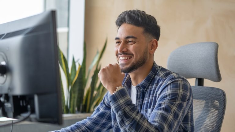 A person smiling with excitement, reflecting their enthusiasm about taking the leap to get into cybersecurity and start a new career path.